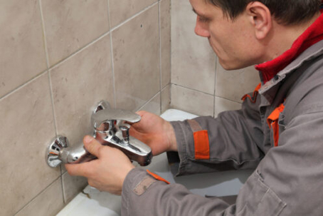 Service tech fixing a faucet