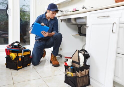 technician checking an undersink