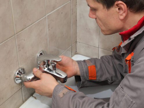 Plumber installing a new bathtub fixture
